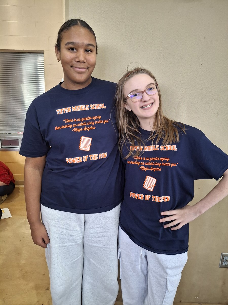 Two Tiffin Middle School students stand side by side wearing navy shirts that read Tiffin Middle School Power of the Pen.